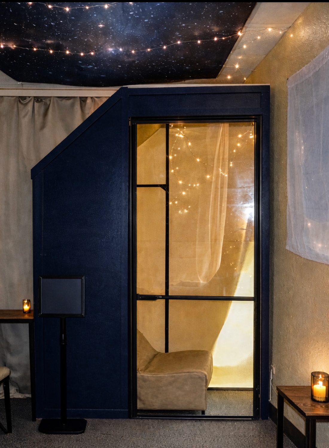 The Resonance Pod room — candlelight beneath a night sky ceiling